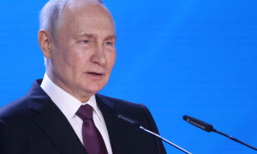 Russian President Vladimir Putin enters the hall during the Russia-Africa International Parliamentary Conference