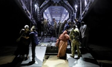 British citizens seen boarding an RAF aircraft in Sudan for evacuation to Cyprus.