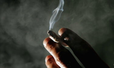 Jonathan Beaver of San Francisco holds a marijuana cigarette at the San Francisco Patients Cooperative