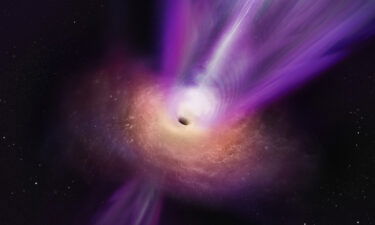 An artist's concept shows how the black hole's massive jet rises up from the center.