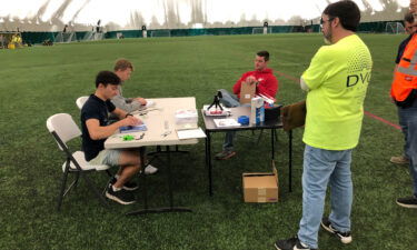 The world record for the farthest flight by paper airplane has been broken by three aerospace engineers with a paper aircraft that flew the length of an American football field. Ruble (from left) and Erickson fold their paper airplanes with witnesses overseeing.