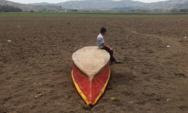 A boy on an abandoned boat on what is left of Lake Atescatempa