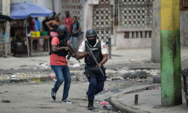 Police officers patrol a neighborhood amid gang-related violence in downtown Port-au-Prince on April 25.