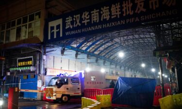 Staff members of the Wuhan Hygiene Emergency Response Team drive their vehicle as they leave the closed Huanan Seafood Wholesale Market in the city of Wuhan