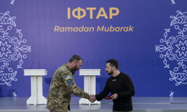 Ukrainian President Volodymyr Zelensky (right) attends an Iftar (fast-breaking) dinner at the Crimean Muslims Center in Kyiv