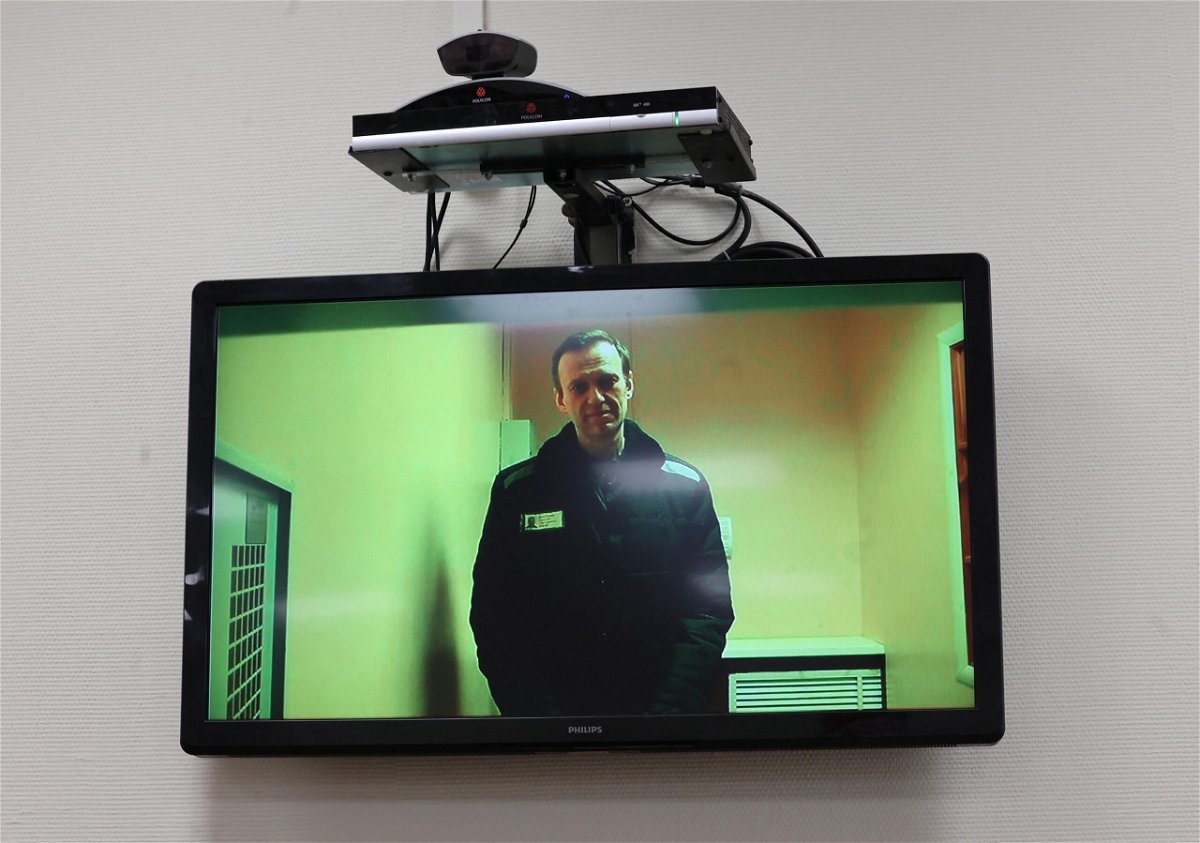 <i>Yulia Morozova/Reuters</i><br/>Russian opposition figure Alexey Navalny is seen on a screen via video link from a penal colony during a court hearing in Moscow.