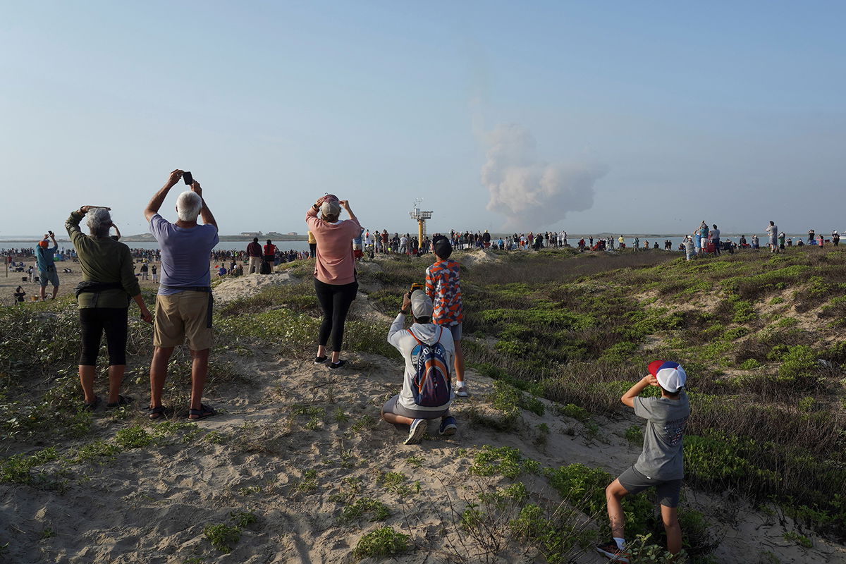 <i>Go Nakamura/Reuters</i><br/>People watch as SpaceX's next-generation Starship spacecraft atop its powerful Super Heavy rocket lifts off from the company's Boca Chica launchpad on a brief uncrewed test flight near Brownsville