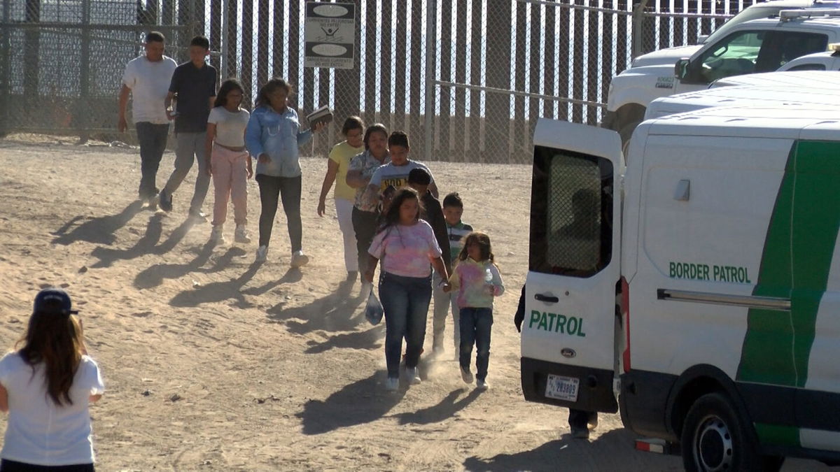 Migrants being loaded into Border Patrol vans in El Paso's lower valley