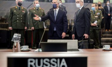 Russian Deputy Foreign Minister Alexander Grushko (R) and NATO Secretary General Jens Stoltenberg (C) arrive to attend the NATO-Russia Council at the Alliance's headquarters in Brussels