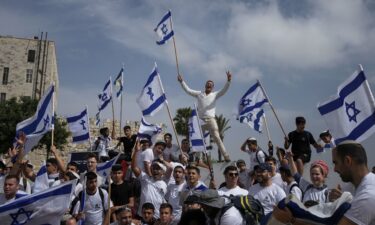 Israelis wave national flags during a march marking Jerusalem Day