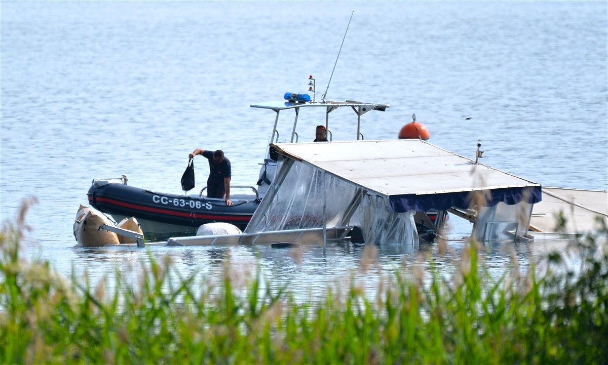 <i>Puricelli/EPA-EFE/Shutterstock</i><br/>Italian authorities are seen inspecting the tourist boat that capsized and sank on Lake Maggiore.
