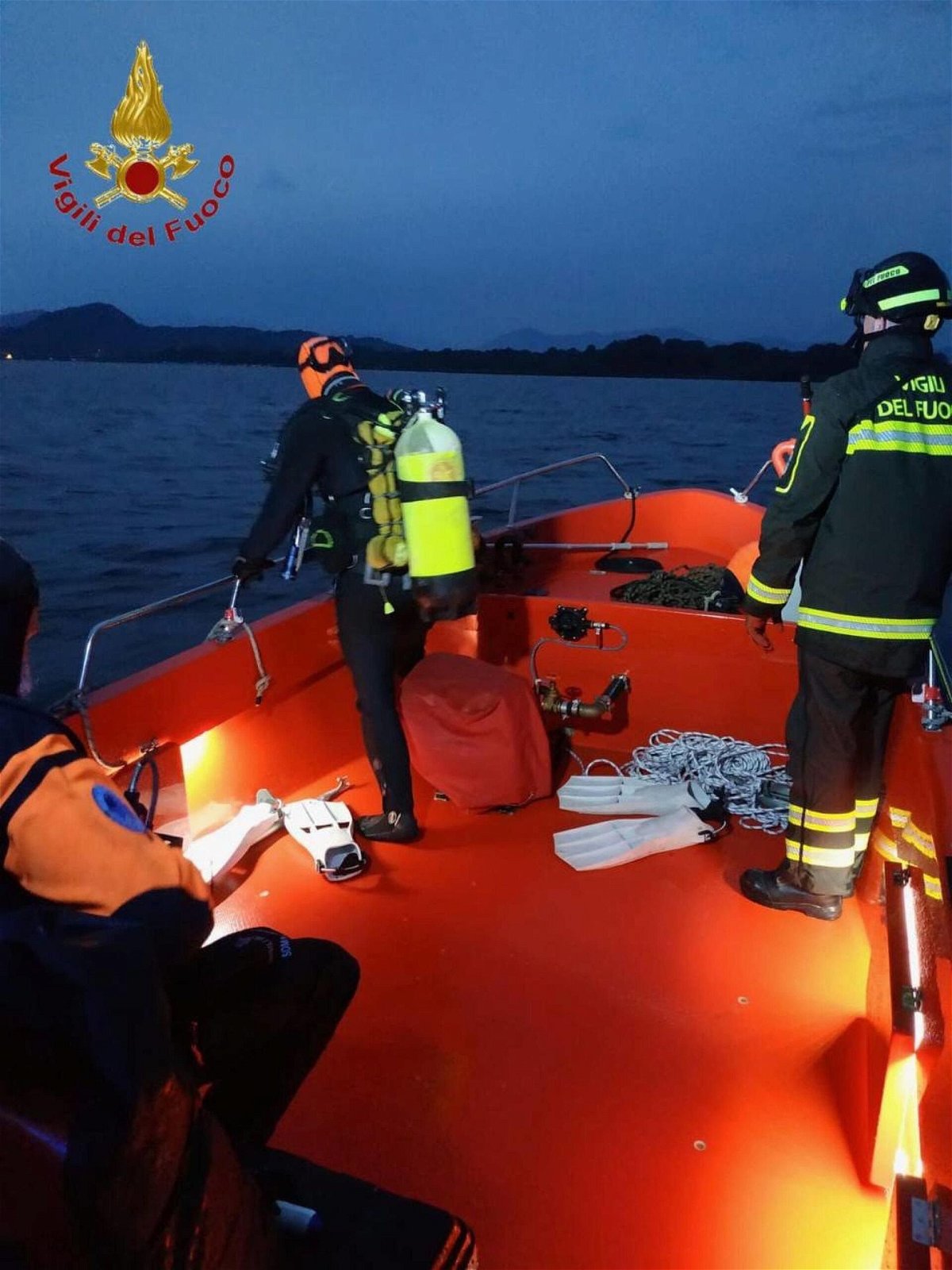 <i>Vigili Del Fuoco/Handout/EPA-EFE/Shutterstock</i><br/>A diver searches for bodies after  a rescue operation in Lake Maggiore