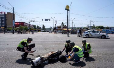 Ukrainian Police officers inspect a fragment a rocket after a Russian attack in Kyiv on Monday.