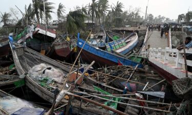 Smashed-up boats are piled up next to a broken bridge in Sittwe