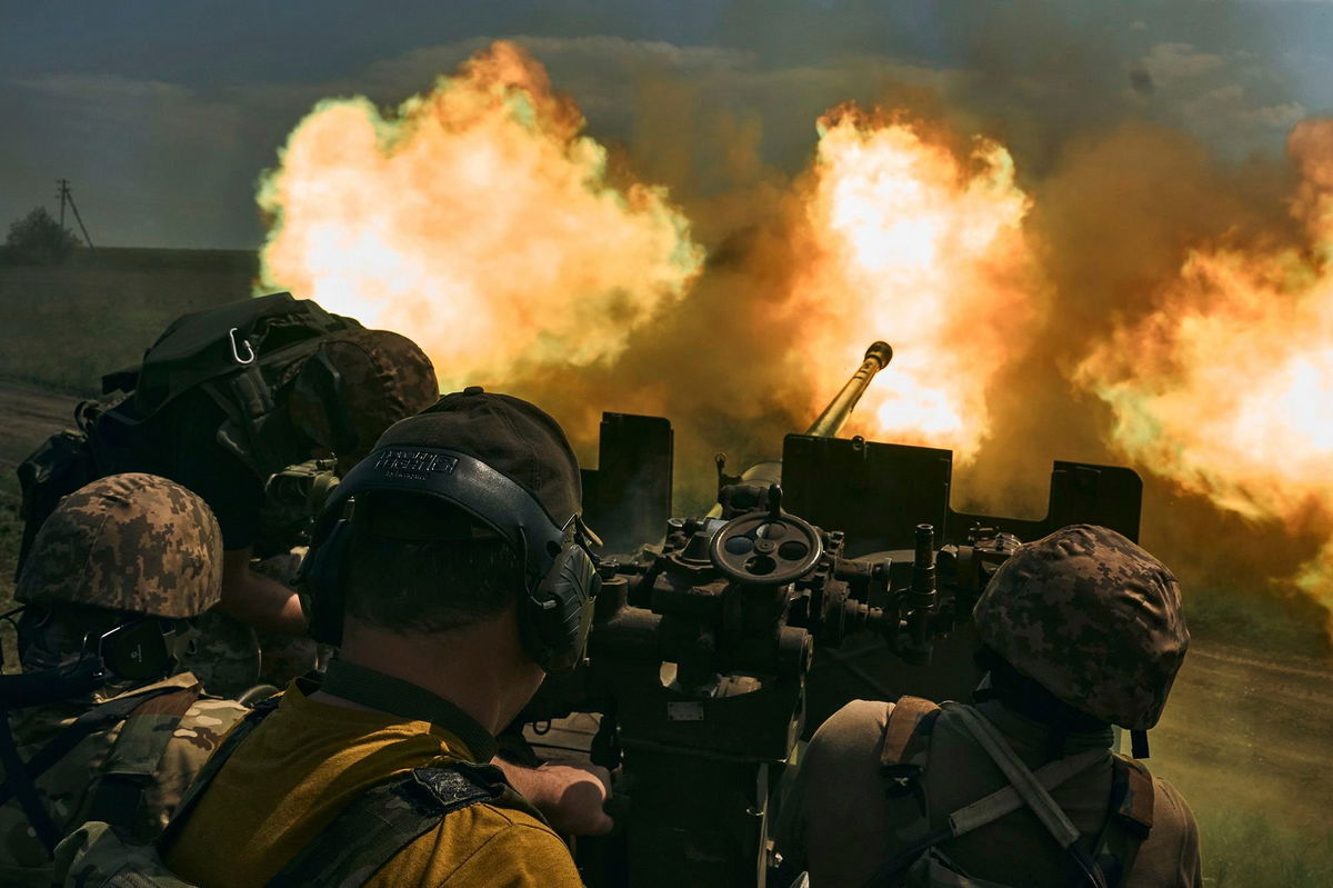 <i>Libkos/AP</i><br/>Ukrainian soldiers fire a cannon near Bakhmut on Monday.