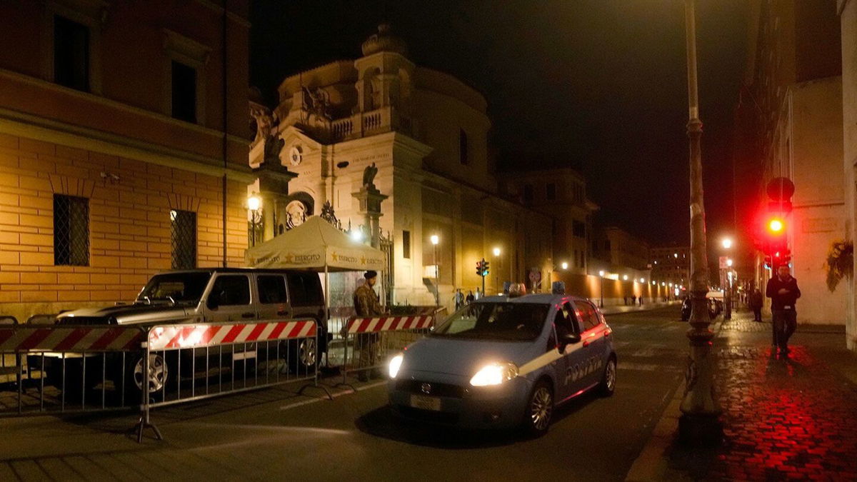 <i>Andrew Medichini/AP</i><br/>An Italian police car passes in front of Santa Anna gate at the Vatican on May 18. A man was arrested after driving through a Vatican gateway on Thursday evening.