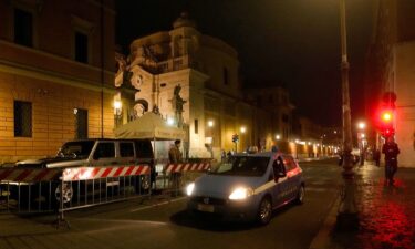 An Italian police car passes in front of Santa Anna gate at the Vatican on May 18. A man was arrested after driving through a Vatican gateway on Thursday evening.