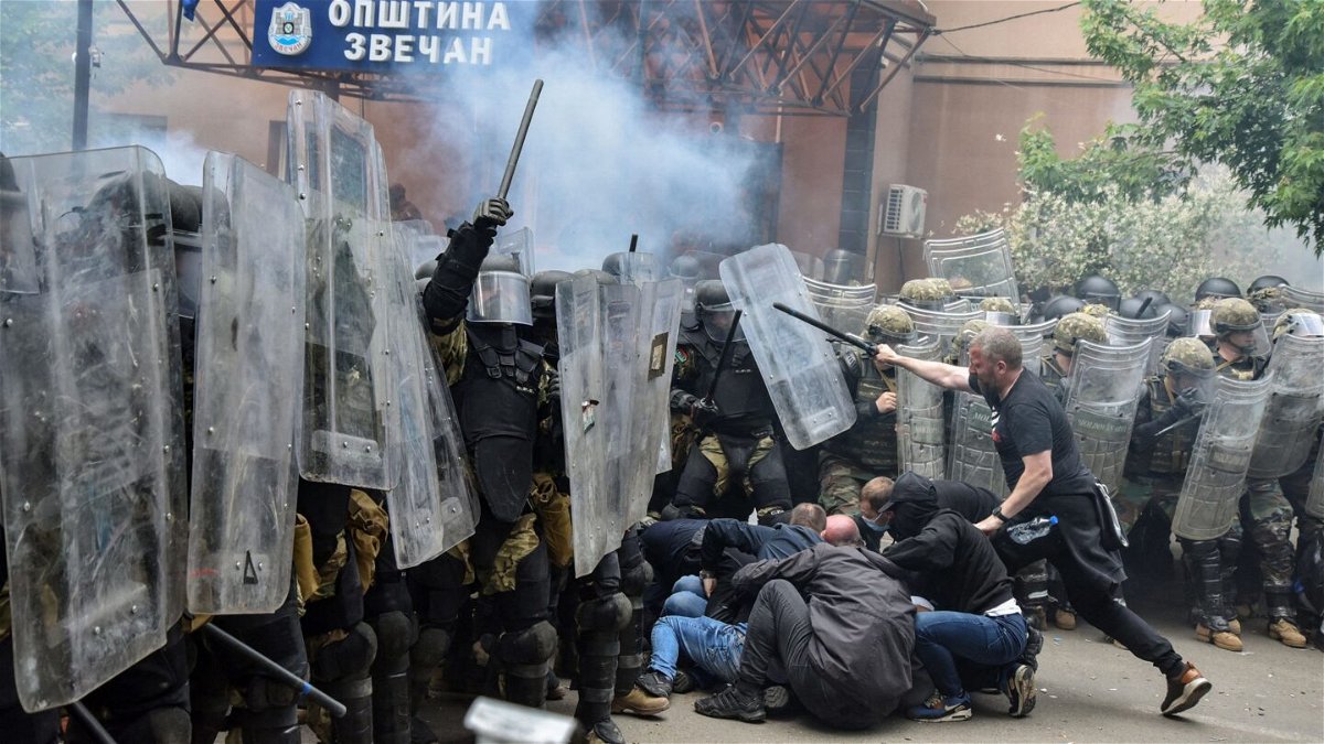 <i>Laura Hasani/Reuters</i><br/>NATO's peacekeeping Kosovo Force (KFOR) clash with local protesters at the entrance of the municipality office