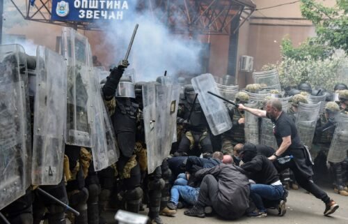 NATO's peacekeeping Kosovo Force (KFOR) clash with local protesters at the entrance of the municipality office