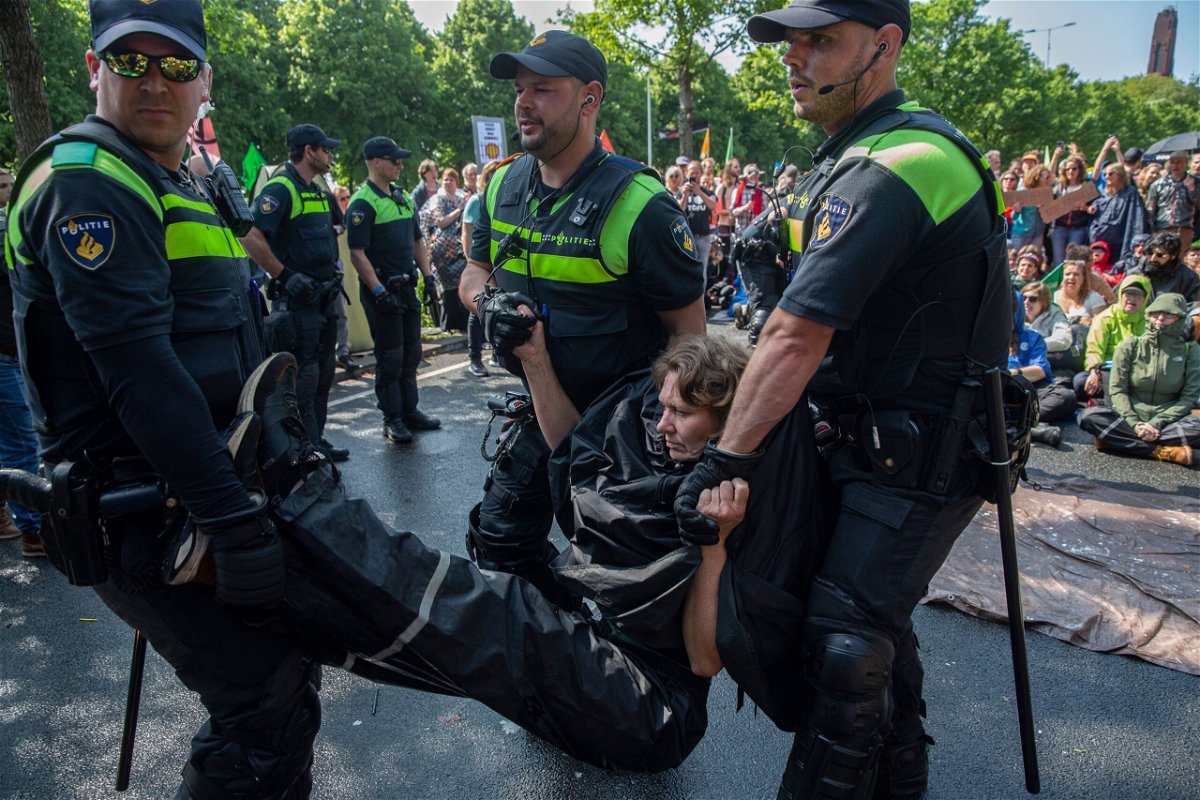 <i>Michel Porro/Getty Images</i><br/>An activist is arrested after blocking the A12 motorway during an Extinction Rebellion led protest to command an end to all fossil fuel subsidies on May 27 in The Hague