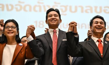 Move Forward Party leader and prime ministerial candidate Pita Limjaroenrat (C) poses with potential coalition partners including Pheu Thai Party leader Chonlanan Srikaew (R) in Bangkok on May 18.