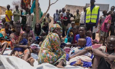 South Sudanese who fled from Sudan sit outside a nutrition clinic at a transit center in Renk