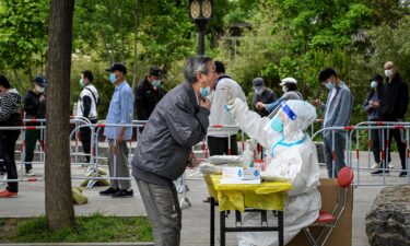 A health worker tests a man for Covid-19 in Beijing last year.