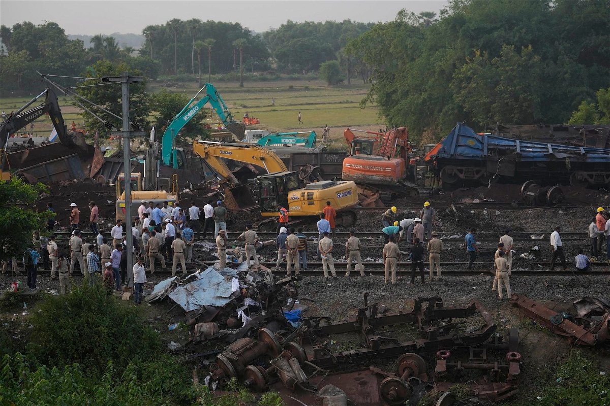 <i>Rafiq Maqbool/AP</i><br/>Policemen stand guard at the site where the trains derailed