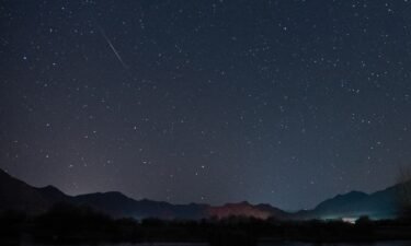 The Geminid meteor shower streaks across the night sky over the Lhasa River in Tibet in December 2022. The Geminid meteor shower