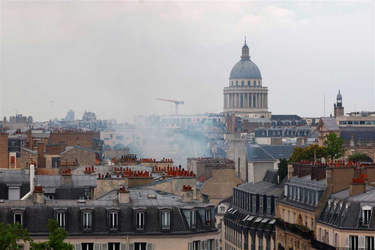 <i>Gonzalo Fuentes/Reuters</i><br/>Smoke rises above rooftops with the Pantheon in the background.
