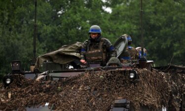 Ukrainian troops ride atop an armored personnel carrier vehicle in the Zaporizhzhia region on June 11.