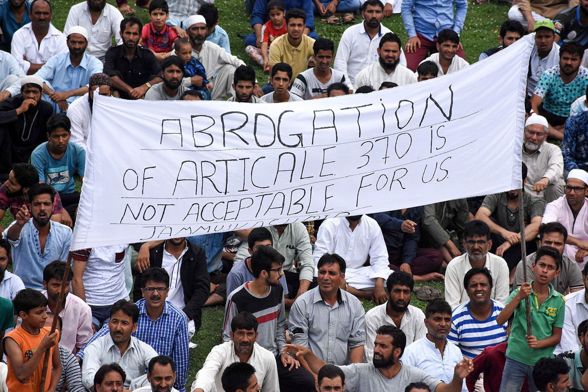 <i>Faisal Khan/Anadolu Agency/Getty Images/File</i><br/>Kashmiri boys hold a banner during a protest against the revoke of controversial Article 370 by Indian government in Srinagar while curfew continues on the fifth day in Kashmir