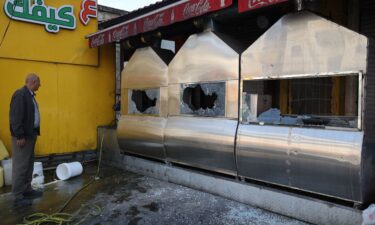 A man inspects the damage to a restaurant following a reported attack by Israeli settlers in Huwara on March 28.