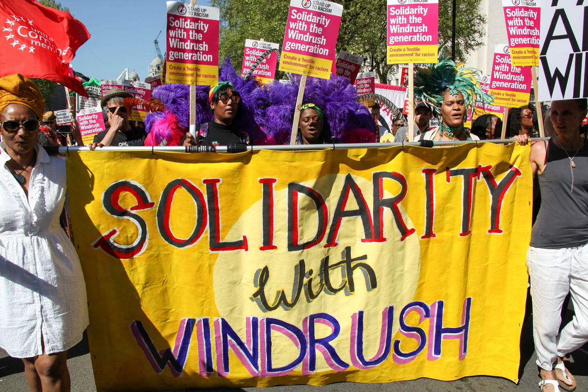 <i>Alex Cavendish/NurPhoto/Getty Images</i><br/>Protesters hold a sign reading 