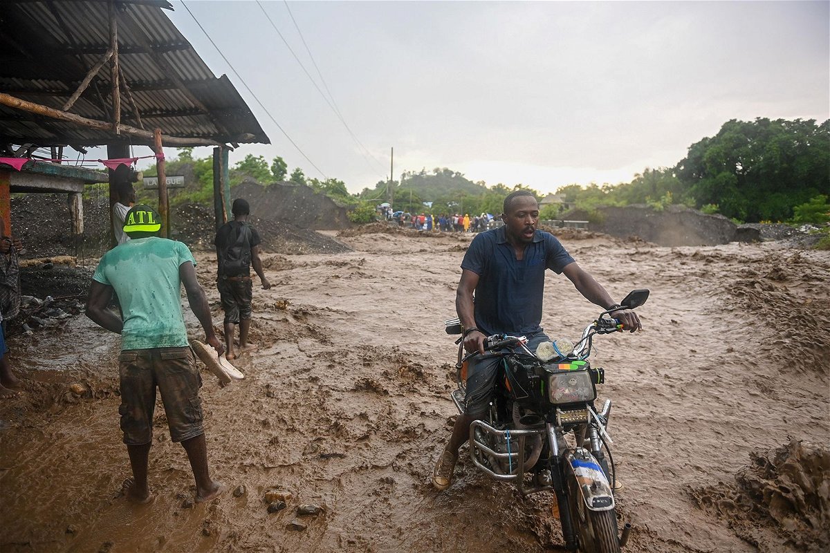 <i>Richard Pierrin/AFP?Getty Images</i><br/>Resident wade through flooded roads in neighborhoods of Petit-Goâve