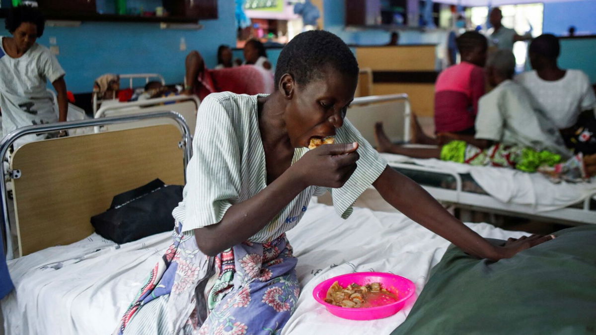 <i>Monicah Mwangi/Reuters</i><br/>A survivor and a follower of Mackenzie's eats a meal inside a ward at the Malindi sub district hospital in April.