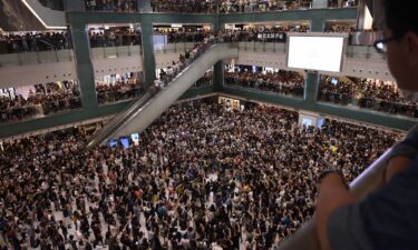 Crowds sing the unofficial protest anthem in a shopping mall in Sha Tin