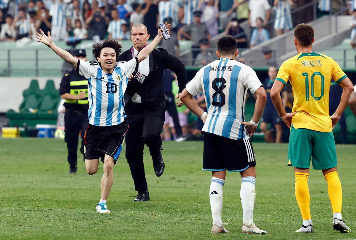 <i>Thomas Peter/Reuters</i><br/>The young pitch invader is chased by security officials during a soccer match between Argentina and Australia at the Workers' Stadium in Beijing