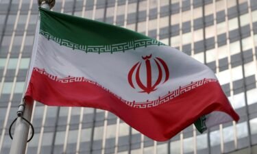 The Iranian flag flutters in front of the International Atomic Energy Agency in Vienna