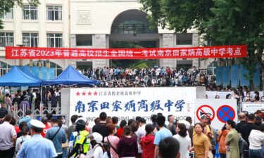 Candidates wait to enter a college entrance exam site in Nanjing