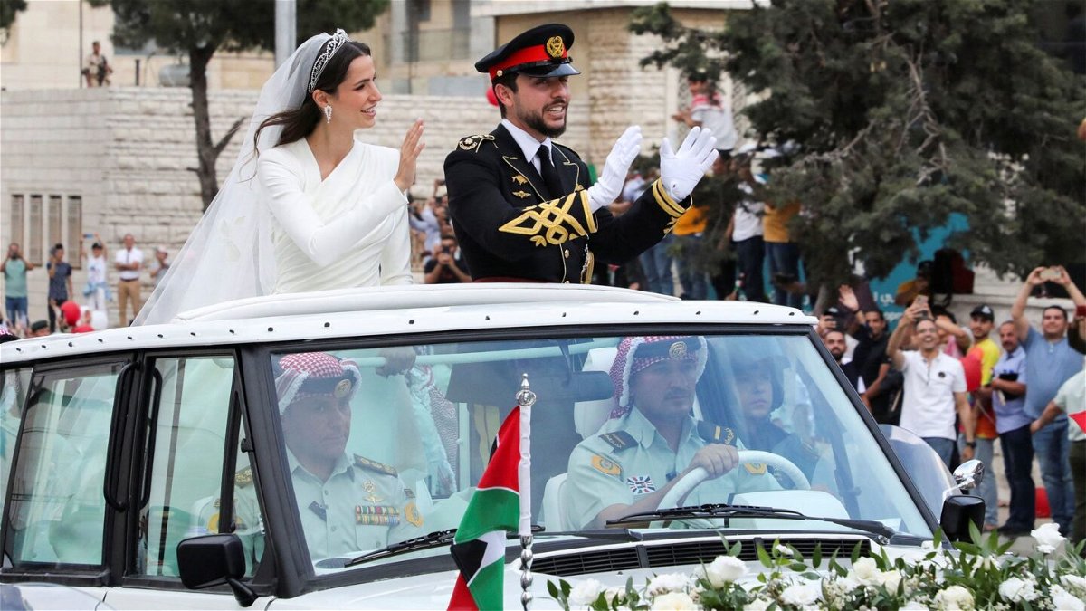 <i>Ahmad Abdo/Reuters</i><br/>Jordan's Crown Prince Hussein (right) and Rajwa Alseif wave to crowds on their wedding day in Amman.