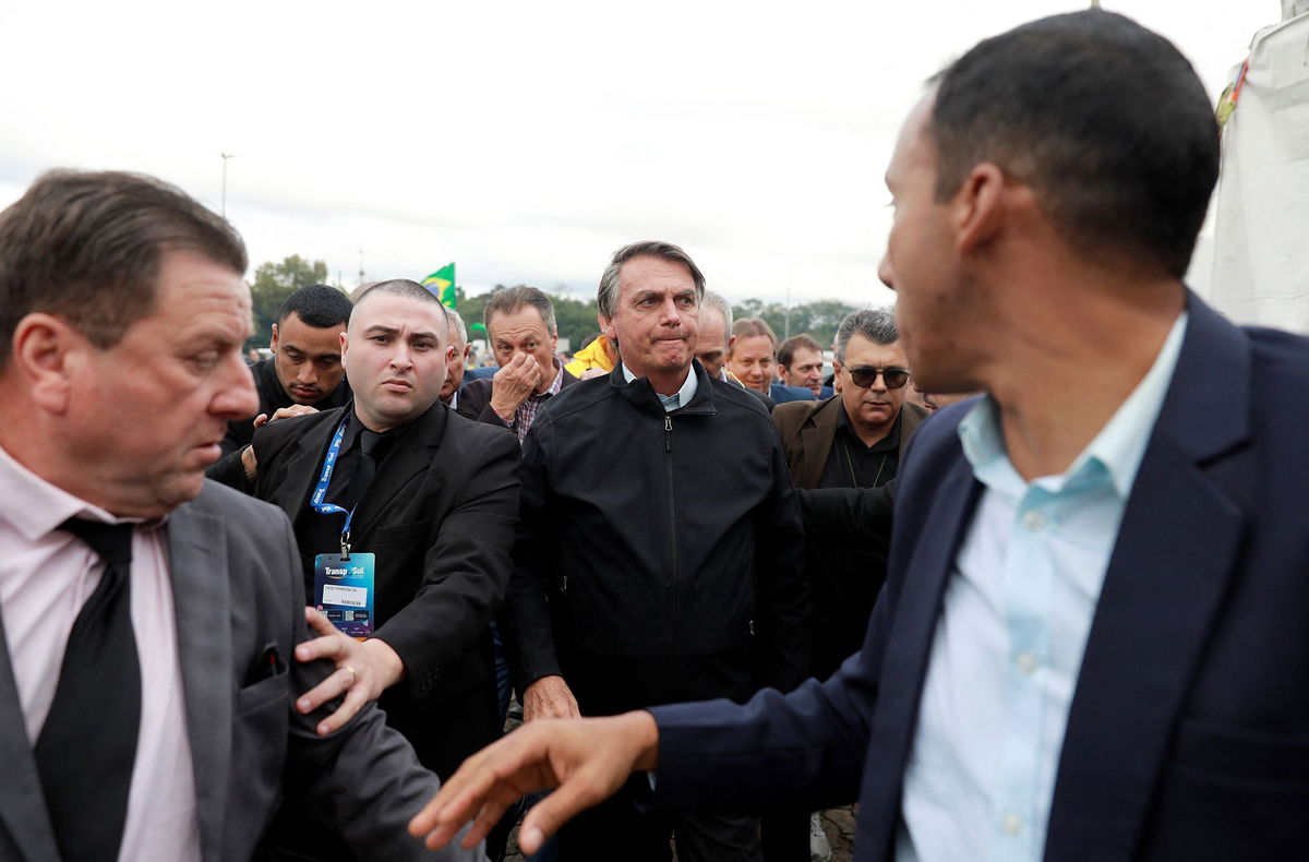 <i>Diego Vara/Reuters</i><br/>Former Brazilian President Jair Bolsonaro’s trial on charges of abuse of political power and misuse of public media began on June 22 in Brasilia. Bolsonaro is pictured here with supporters on Thursday.