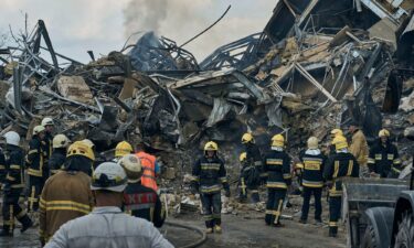 Emergency service personnel work at the site of a destroyed building after a Russian attack in Odesa