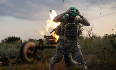 A Ukrainian serviceman of the 3rd Assault Brigade fires a 122mm mortar towards Russian positions at the front line