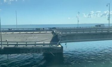 A view shows the section of a road split and sloping to one side following an alleged attack on the Crimea Bridge