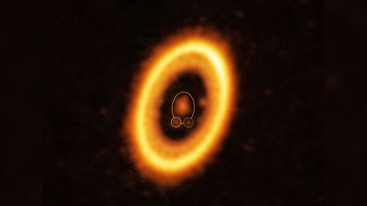 <i>ALMA (ESO/NAOJ/NRAO)/Balsalobre-Ruza et al.</i><br/>A cloud of debris (circled by a yellow dotted line) may be a newly forming planet in the same orbit as the planet PDS 70b.