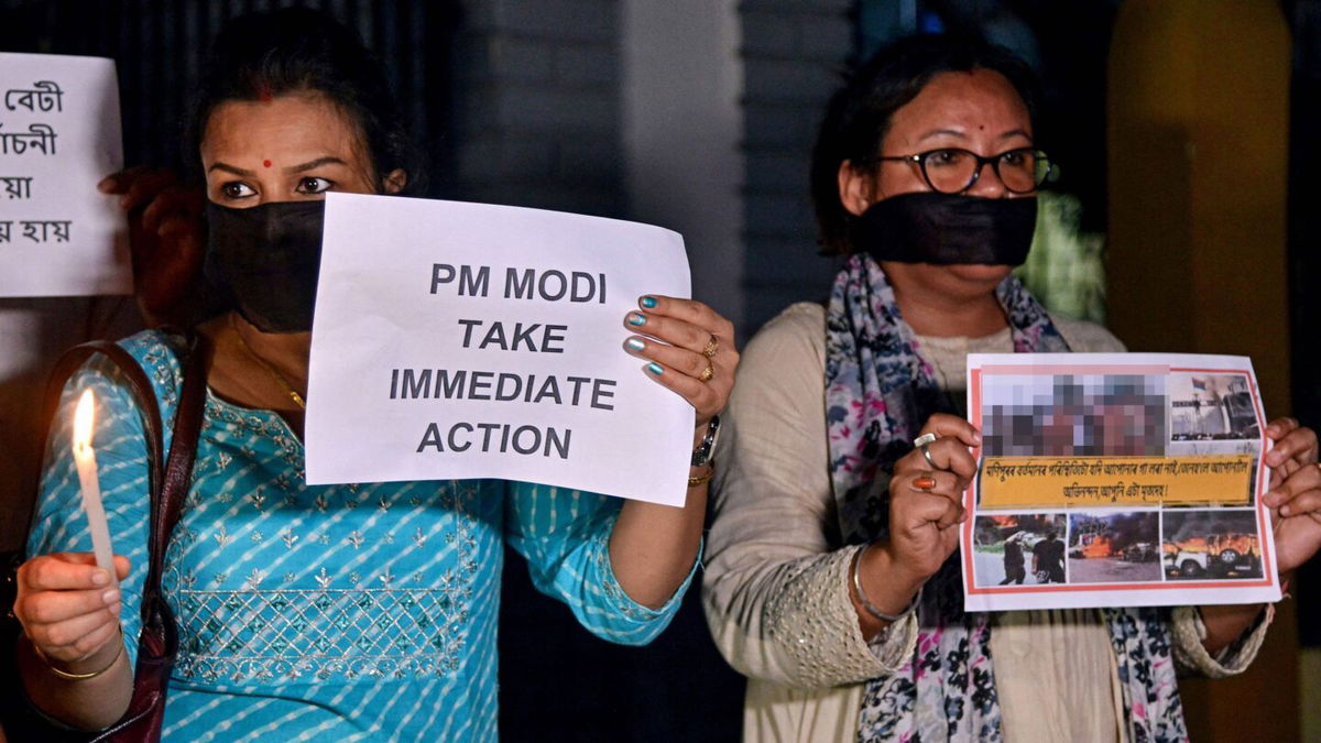 <i>Biju Boro/AFP via Getty Images</i><br/>Protesters hold placards during a demonstration over sexual violence against women in Manipur