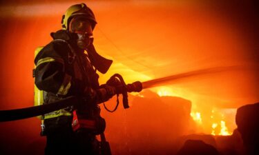 A firefighter works at a site of storage facilities hit during Russian missile and drone strikes