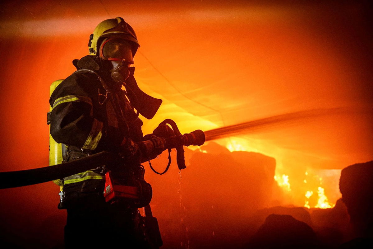 <i>Ukrainian Presidential Press Service/Reuters</i><br/>A firefighter works at a site of storage facilities hit during Russian missile and drone strikes