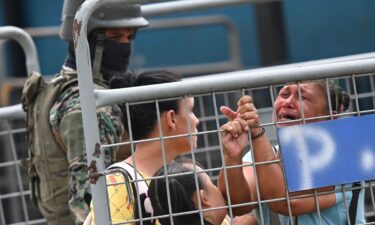 A woman cries outside outside the Guayas 1 prison a day after a fight between rival gangs left six inmates dead in Guayaquil